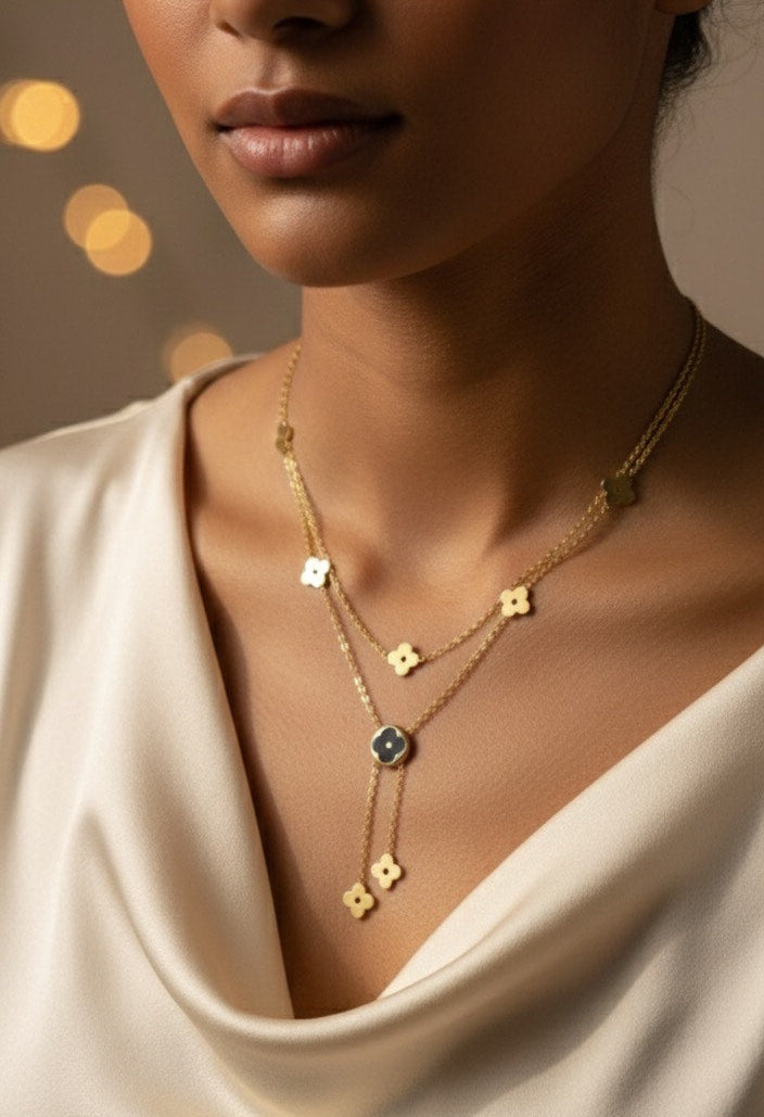 Woman wearing a gold necklace with a blurred background