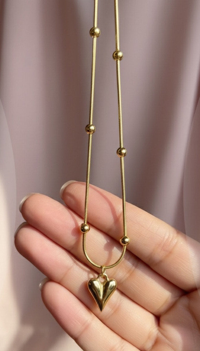 "This necklace offers bold, feminine elegance with a fashionable edge. Featuring a delicate Y-drop design, four intricately textured gold heart charms cascade gracefully, instantly lengthening your silhouette. Crafted from durable material with a tarnish-free golden finish that stays brilliant. It's the perfect modern statement piece for any neckline.
"
