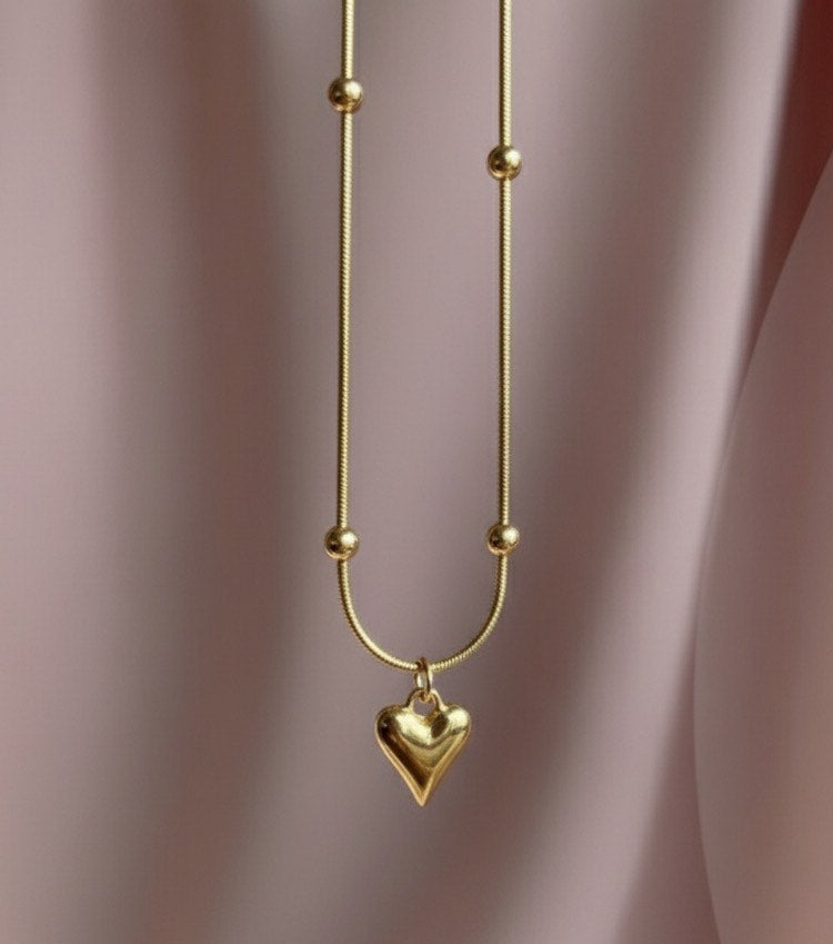 "This necklace offers bold, feminine elegance with a fashionable edge. Featuring a delicate Y-drop design, four intricately textured gold heart charms cascade gracefully, instantly lengthening your silhouette. Crafted from durable material with a tarnish-free golden finish that stays brilliant. It's the perfect modern statement piece for any neckline.
"
