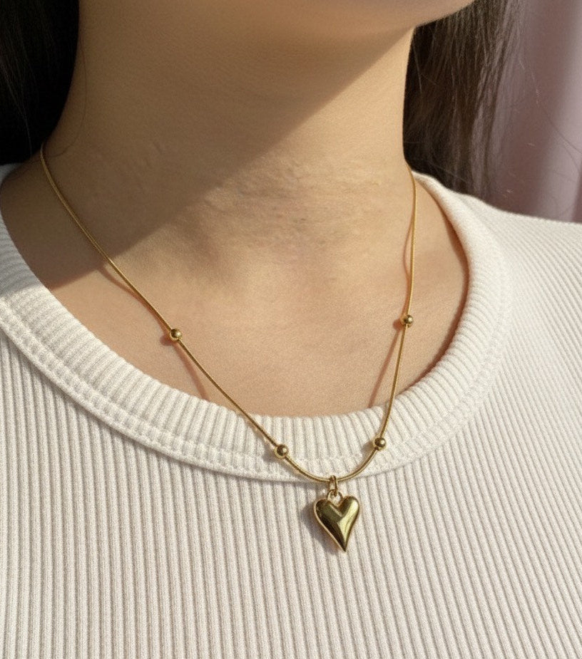 "This necklace offers bold, feminine elegance with a fashionable edge. Featuring a delicate Y-drop design, four intricately textured gold heart charms cascade gracefully, instantly lengthening your silhouette. Crafted from durable material with a tarnish-free golden finish that stays brilliant. It's the perfect modern statement piece for any neckline.
"
