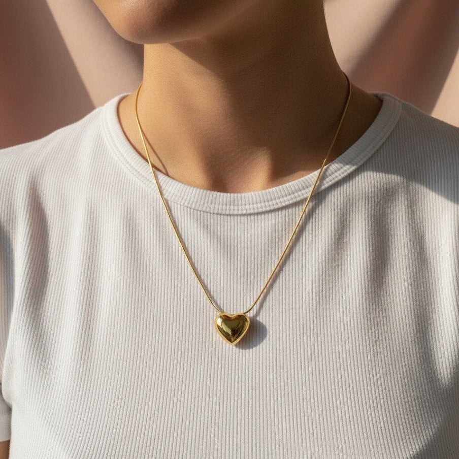 The Heart Pendant  beautifully blends with refined grace. Meticulously crafted from high-polish sterling gold, it captures a whimsical, design that is both delicate and captivating.
